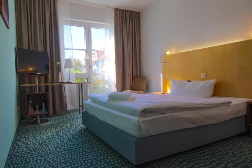 Postel nebo postele na pokoji v ubytování Check Inn Hotel Merseburg