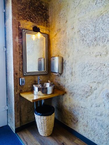 a bathroom with a sink and a mirror at Poveira Hotel in Porto