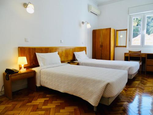 Ліжко або ліжка в номері Poveira Hotel