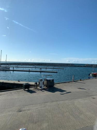 a dock next to a large body of water at Pakhuset Anholt in Anholt