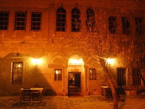 a building at night with lights in front of it at Kapadokya Ihlara Konakları Otel Konak Odaları in Guzelyurt