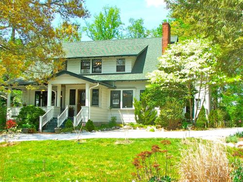 a white house with a green roof at Oakland Cottage Bed and Breakfast in Asheville