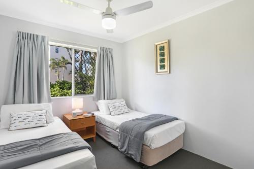 a bedroom with two beds and a window at Chidori Court in Gold Coast