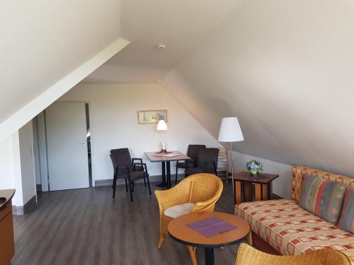 ein Wohnzimmer mit Sofa und Tisch in der Unterkunft Ferienwohnung 19 im Strandhaus Lobbe in Lobbe