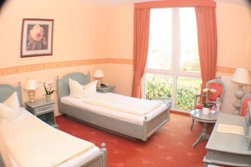
Ein Bett oder Betten in einem Zimmer der Unterkunft Kurpark Hotel Bad Lauchstädt
