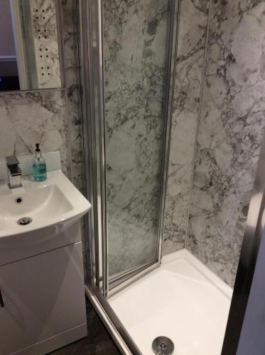 a bathroom with a shower and a sink at The Camberley in Harrogate