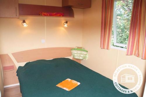a small room with a green table and a window at Camping Montana Parc - Gassin Golfe de St Tropez - Maeva in Gassin