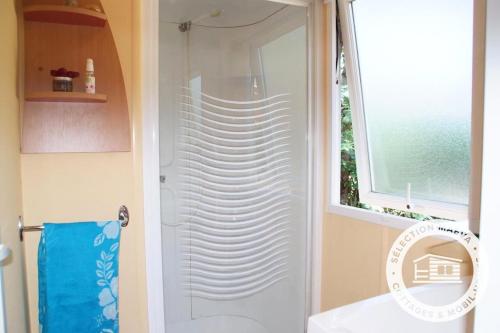 a shower with a glass door in a bathroom at Camping Montana Parc - Gassin Golfe de St Tropez - Maeva in Gassin