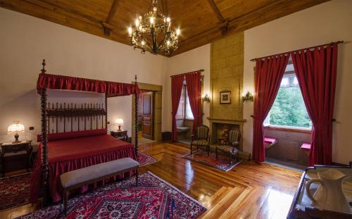 a bedroom with a bed and a chandelier at Solar de Serrade in Monção