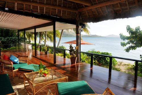 a porch of a resort with a view of the ocean at Nukubati Great Sea Reef in Nukubati