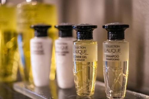 a group of bottles of oil sitting on a shelf at Hotel du Nord, Hamburg-Volksdorf in Hamburg
