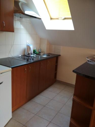 a kitchen with a sink and a skylight at VITA Augustów in Augustów