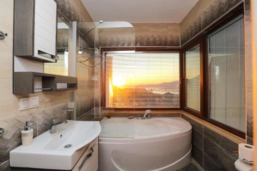 a bathroom with a sink and a toilet and a window at Villa Horizon in Dalyan