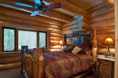 a bedroom with a bed in a log cabin at 67 El Capitan in North Wawona