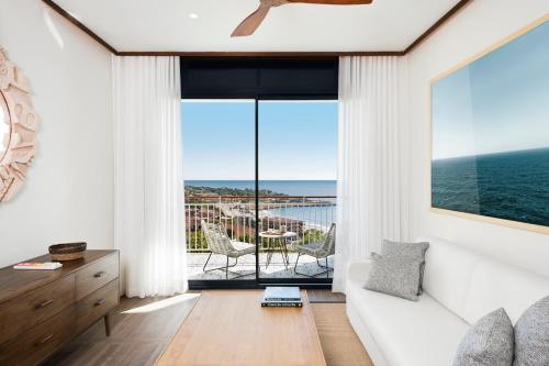 a living room with a view of the ocean at H10 Imperial Tarraco 4* Sup in Tarragona