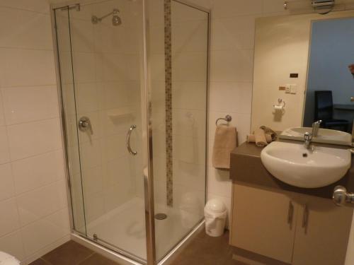 a bathroom with a shower and a sink at Ballarat Central City Motor Inn in Ballarat