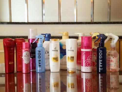 a group of bottles of hair products on a counter at Hotel Fine Tsu in Tsu