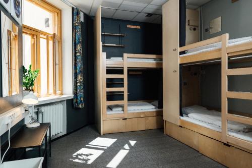 a dorm room with bunk beds and a desk at The Yard Hostel in Helsinki