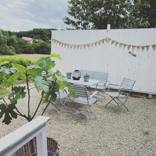 a patio with a table and chairs and a fence at Ferienhaus No. 4 in Perl
