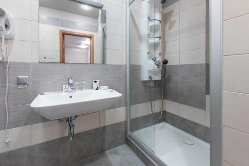 a bathroom with a sink and a shower at Valensija in Jūrmala