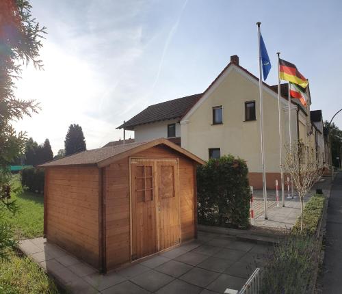 a small wooden shed in front of a house at Studio Wille in Lünen