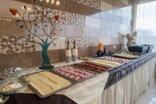 a buffet with meats and other food on a table at Hotel Vital in Zalakaros