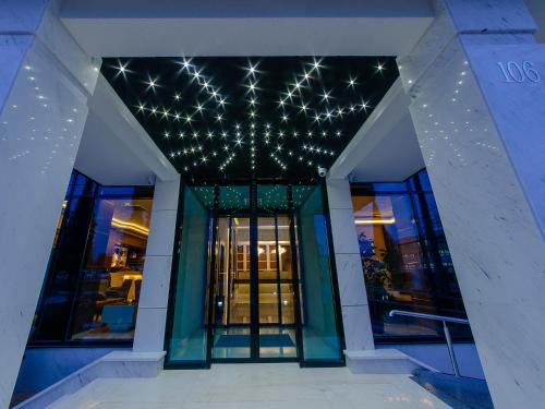 a building with christmas lights on the ceiling at Hotel New Star in Podgorica