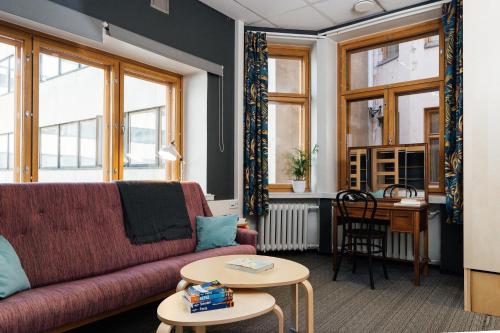 a living room with a couch and a table at The Yard Hostel in Helsinki