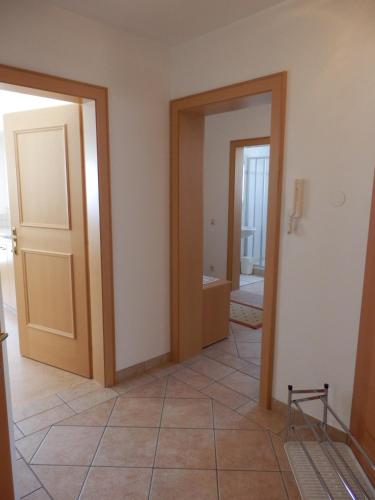 a room with two doors and a tile floor at Haus Sonnental in Filzmoos