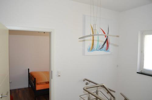 a room with a white wall with a painting on the wall at Ferienhaus Köhler in Marienberg