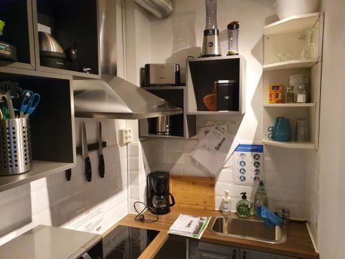 a kitchen with a sink and a counter top at Brukshotellet Skinnsberg in Skinnskatteberg