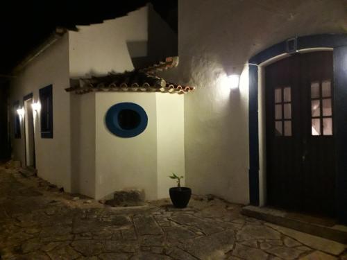 a house with a potted plant in front of it at night at Quinta Da Silva in Vale dos Ovos