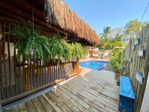 a house with a wooden deck and a swimming pool at VILA TRANCOSEAR in Trancoso