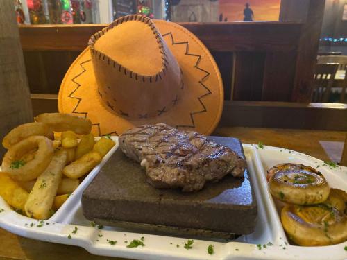 a plate of food with a steak and a baseball at The Parkers Arms - The home of Cattlemans Steakhouse in Paignton