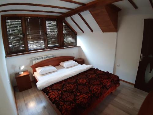 a bedroom with a bed with two pillows on it at Tora Bora Guest House in Pancharevo