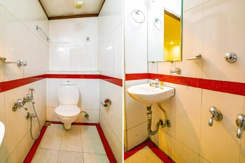 a bathroom with a toilet and a sink at Hotel Pearl Palace in Cochin