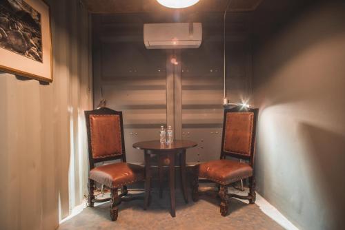 a table and two chairs in a room at Hotel Castillo Ferrer in Valle de Guadalupe