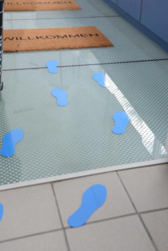 a floor with blue footprints on the floor at Space Home Apartment - Inner City in Vienna