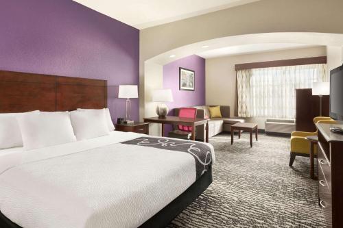 a hotel room with a large bed and a desk at La Quinta by Wyndham Fresno Northwest in Fresno