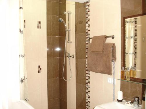 a bathroom with a shower with a toilet and a sink at Most City Premium apartments in Dnipro