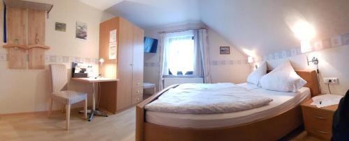 a small bedroom with a bed and a window at Gasthof & Pension Erlengrund in Gersfeld