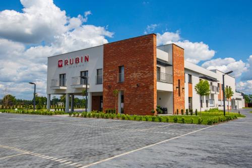 a brick building with a sign on it at Hotel Rubin in Stara Blotnica
