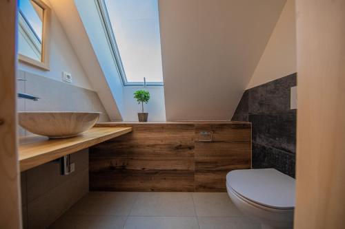 a bathroom with a wooden sink and a toilet at Chatička u řeky - Kouty nad Desnou in Loučná nad Desnou