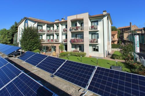 a group of solar panels on the roof of a building at Hotel Eden in Valeggio sul Mincio
