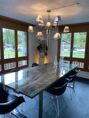 a dining room with a large wooden table and chairs at Luxury family apartment Engelberg in Engelberg