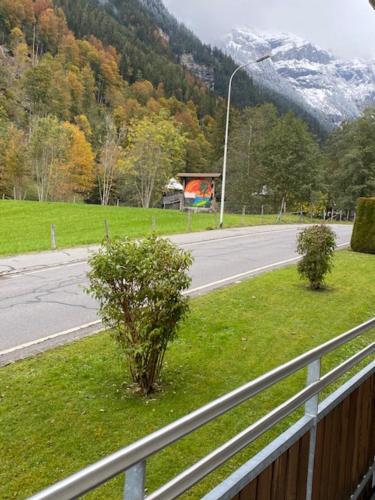 a view of a road with trees and a fence at Luxury family apartment Engelberg in Engelberg