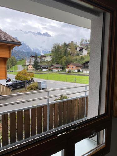 a window with a view of a street from a house at Luxury family apartment Engelberg in Engelberg