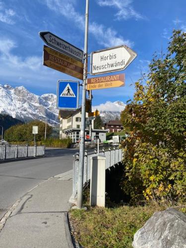 a pole with street signs on the side of a road at Luxury family apartment Engelberg in Engelberg