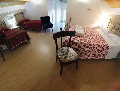 a bedroom with a bed with a red and white blanket at Residenza delle Grazie in Miglionico