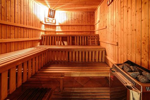 an inside of a sauna with a bench in it at Hotel Fenix in Jelenia Góra